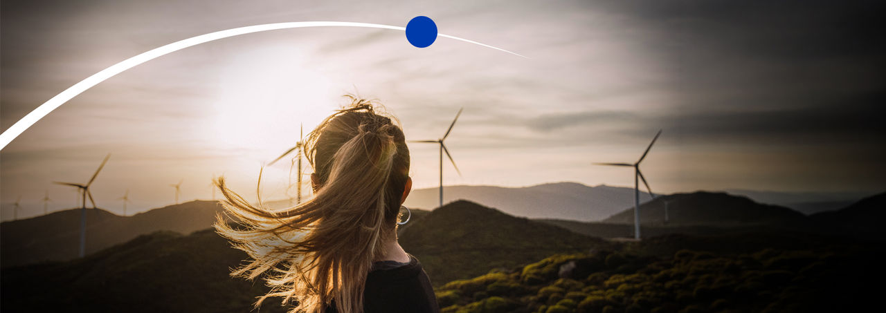 woman with hair in the wind, windmills, new energy